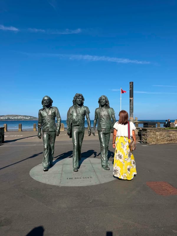 A photograph beside the Bee Gees statues, from Edna’s remembrance post